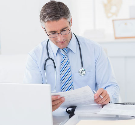Male doctor reviewing paperwork